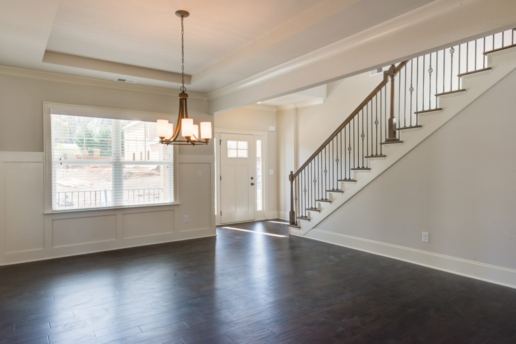 Open Dining Room to Foyer with Tall Wainscoting and Trey Ceiling - Two Story Foyer